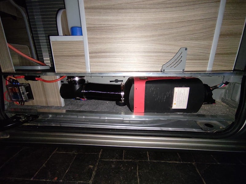 Diesel heater installed under the kitchen unit in a camper van