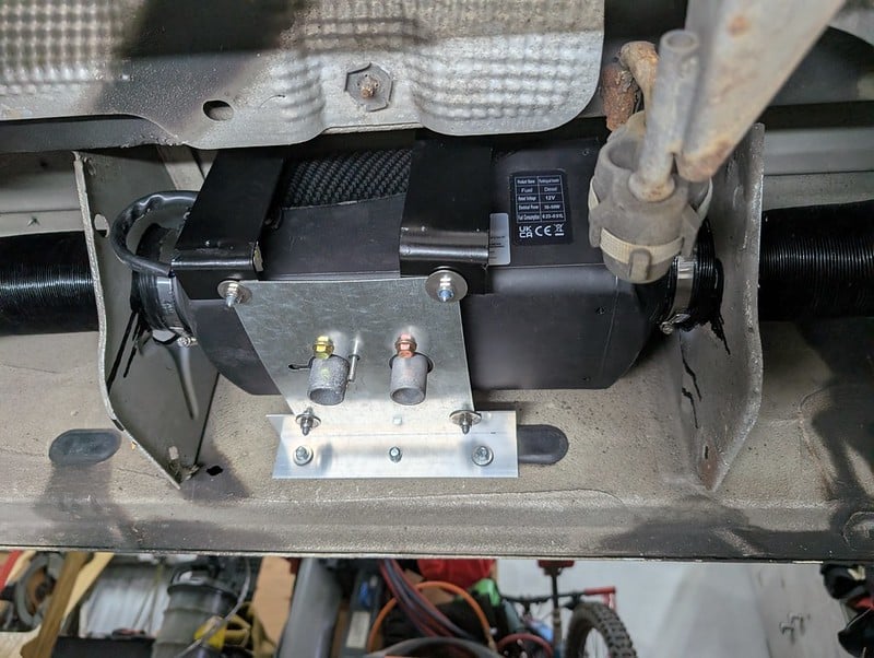Diesel heater installation underneath a camper van floor by XVC Campers